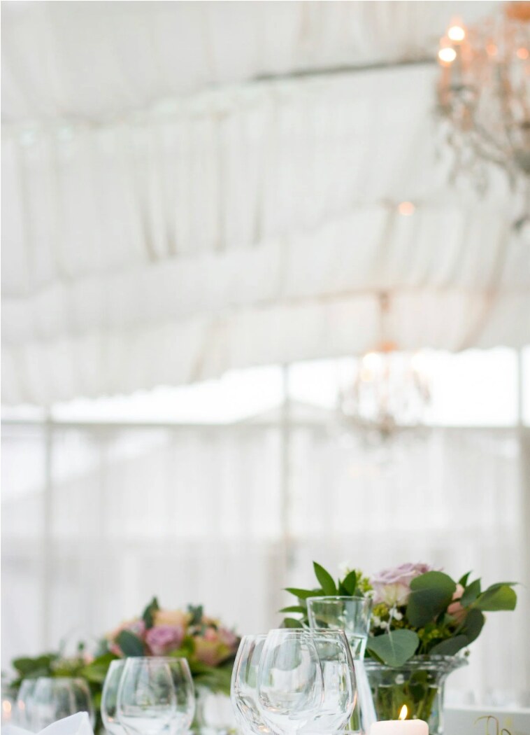A candlelit wedding reception table with flowers